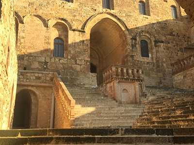 The entranceway to an ancient sandstone stone monastery.