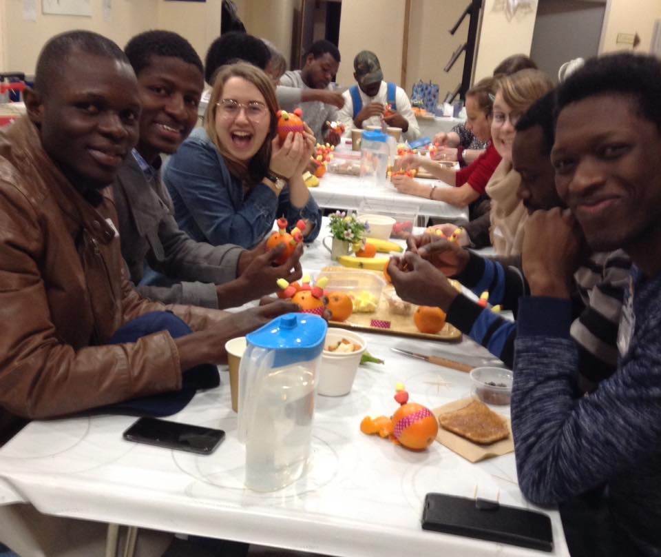 Smiling people making Christingles.