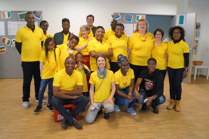 A group wearing yellow t-shirts at All Saints Church.