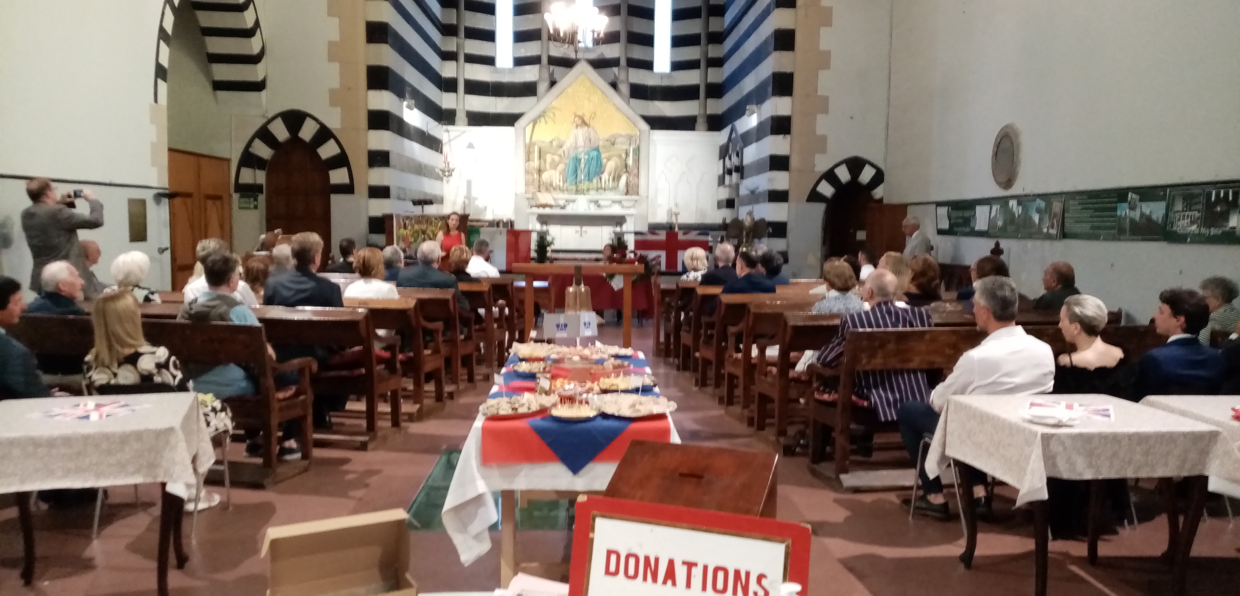 A church in Genoa with a table of sandwiches in the center.