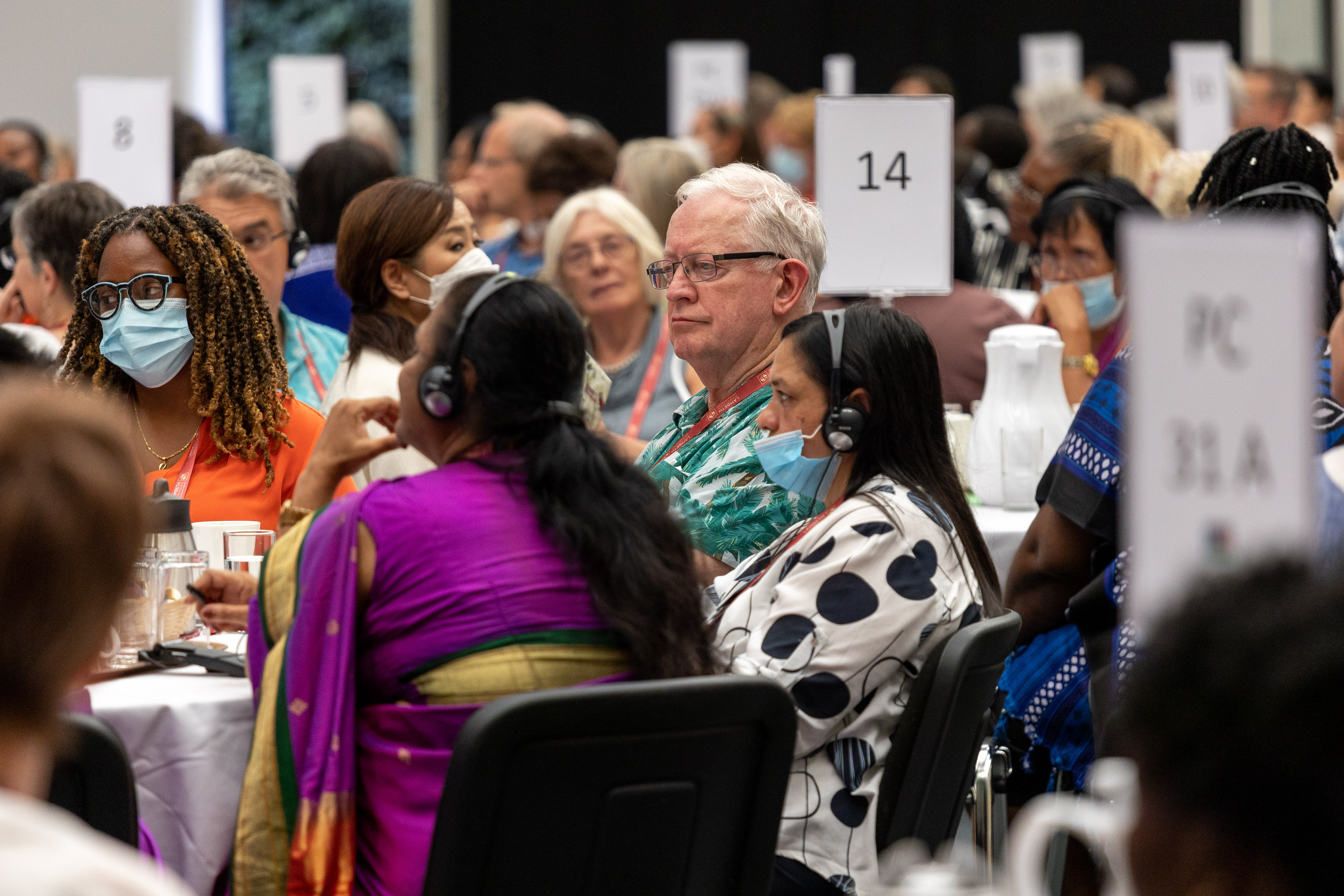 People sat at round tables for a conference.
