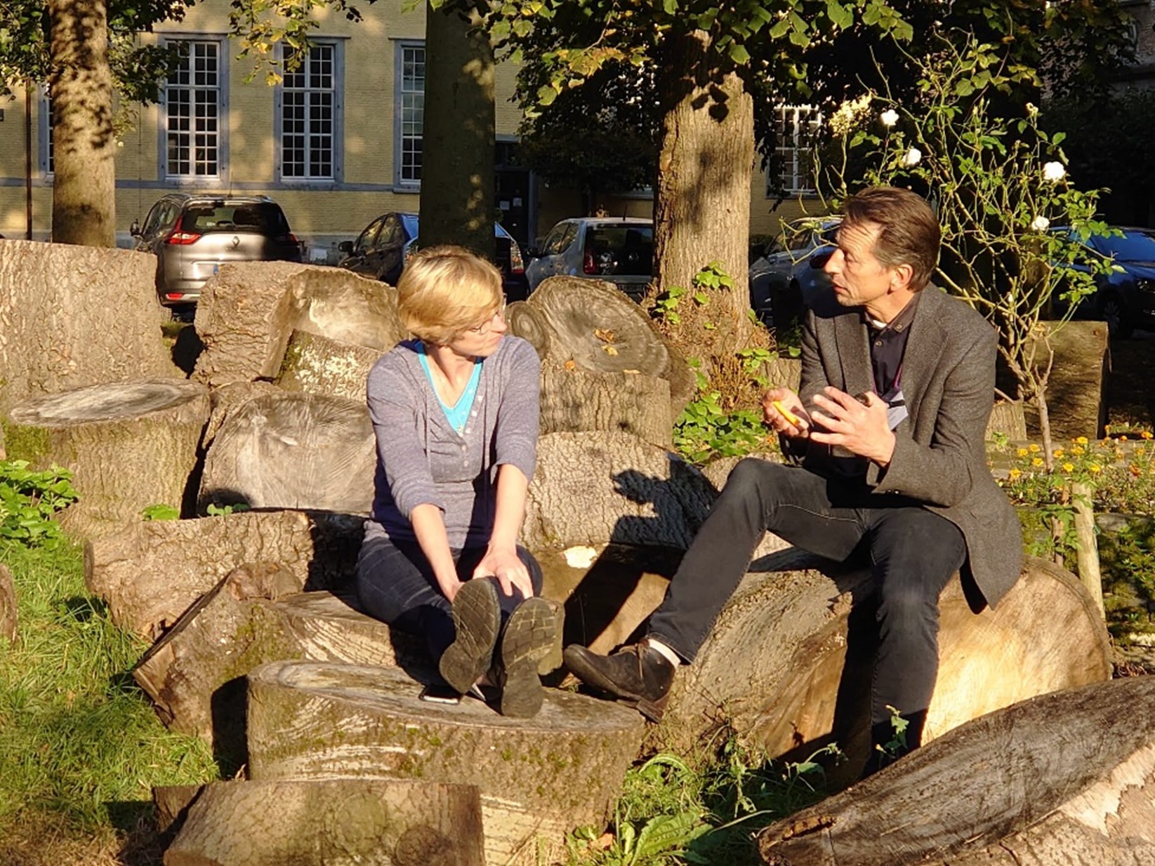 Two people chatting on a rock.