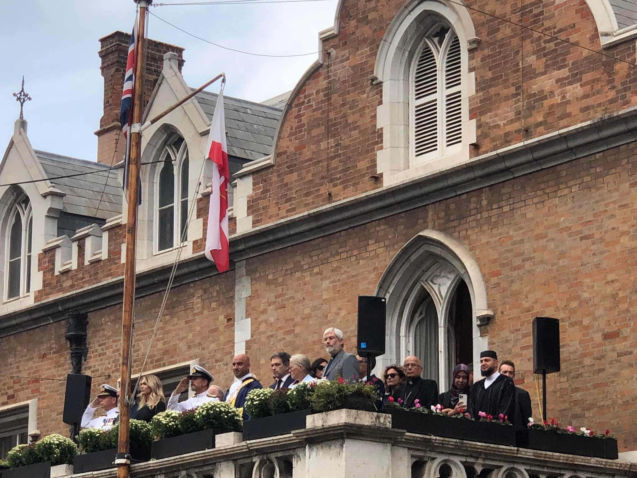 People gathered on a balcony after the death of the Queen.