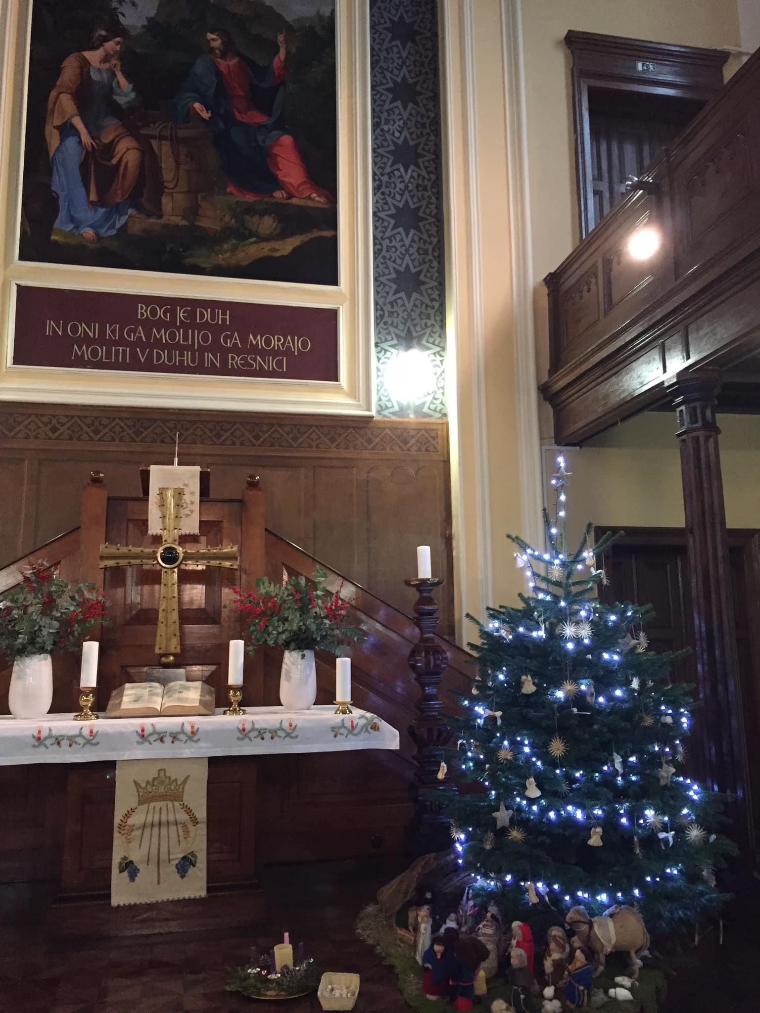 A christmas tree near an altar.