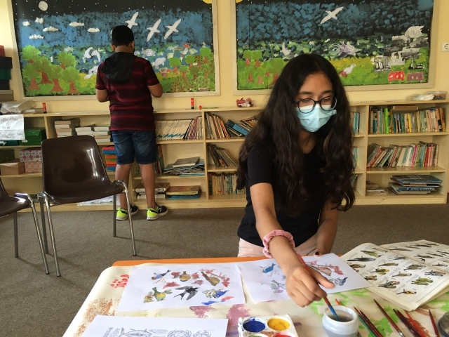 Children painting creatures in Barcelona.