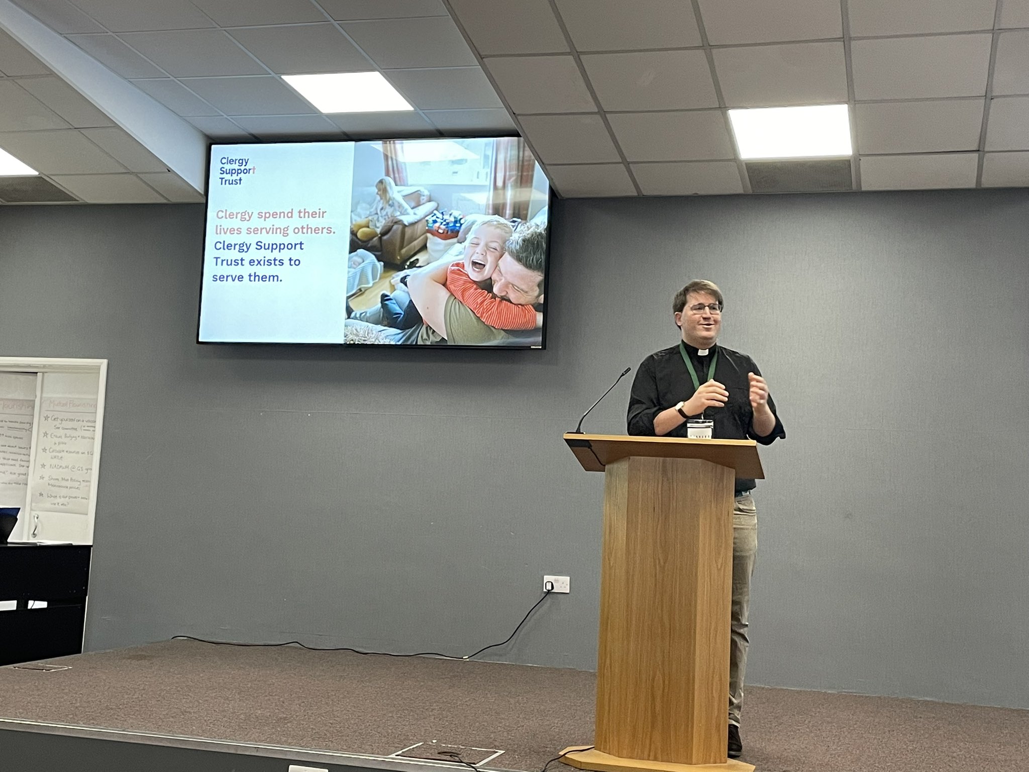 A man giving a talk on womens ministry.