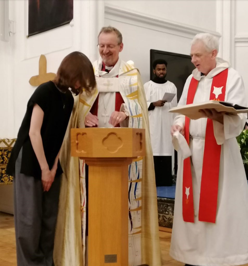 Bishop Robert Baptizes Liliya.