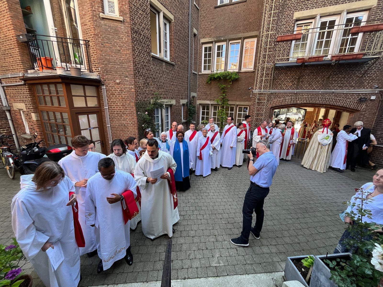 A photographer takes photos of a row of clergy