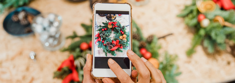 mobile phone taking a photo of christmas wreaths