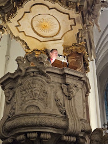 Looking up to a very high pulpit in Berlin with Bishop Robert's face appearing