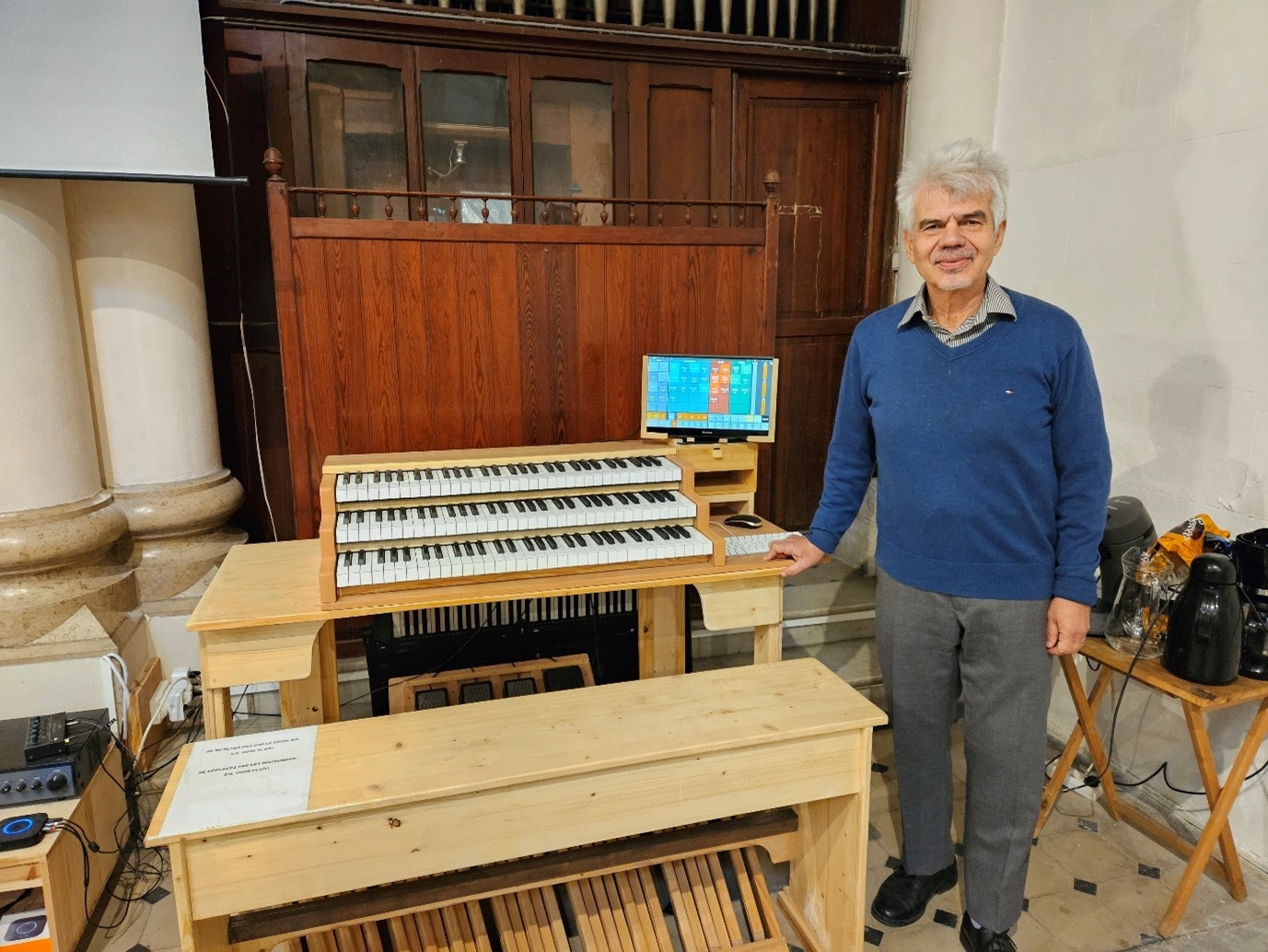 Man standing next to an organ