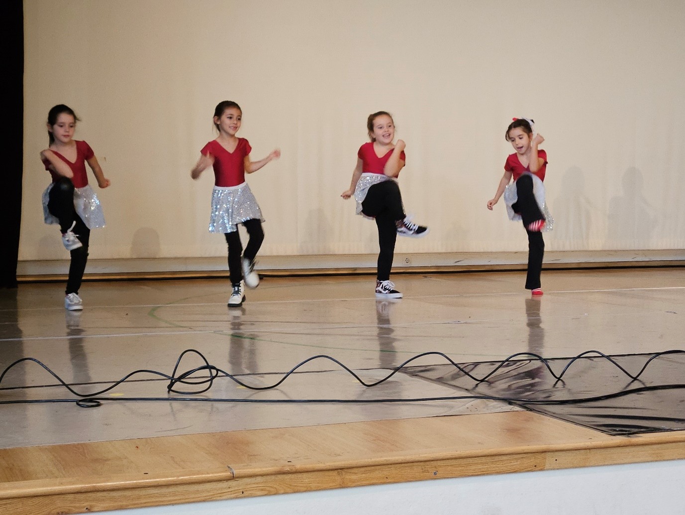 4 young girls do a dance