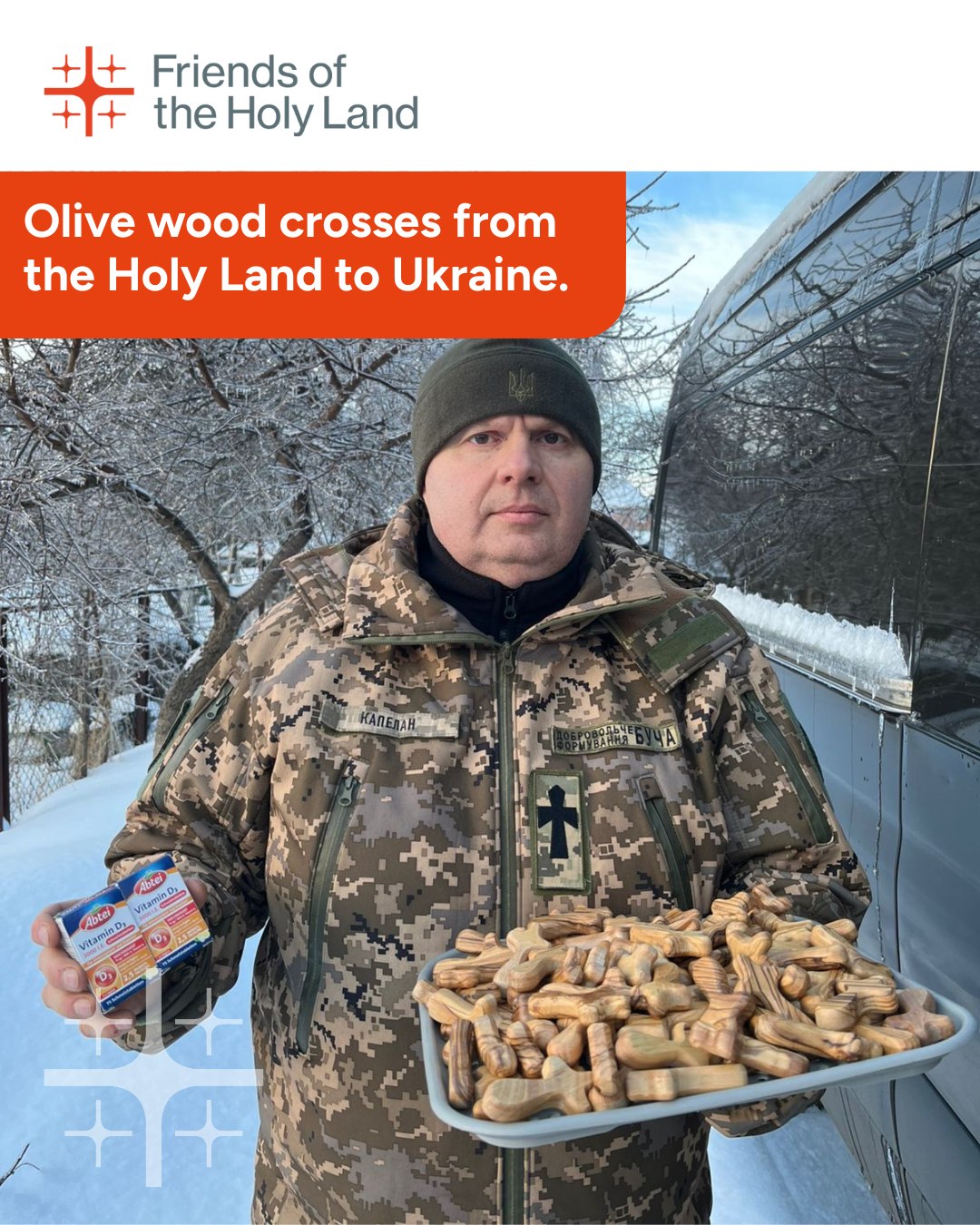 A Facebook post from Friends of the Holy Land of an army chaplain holding olive wood crosses