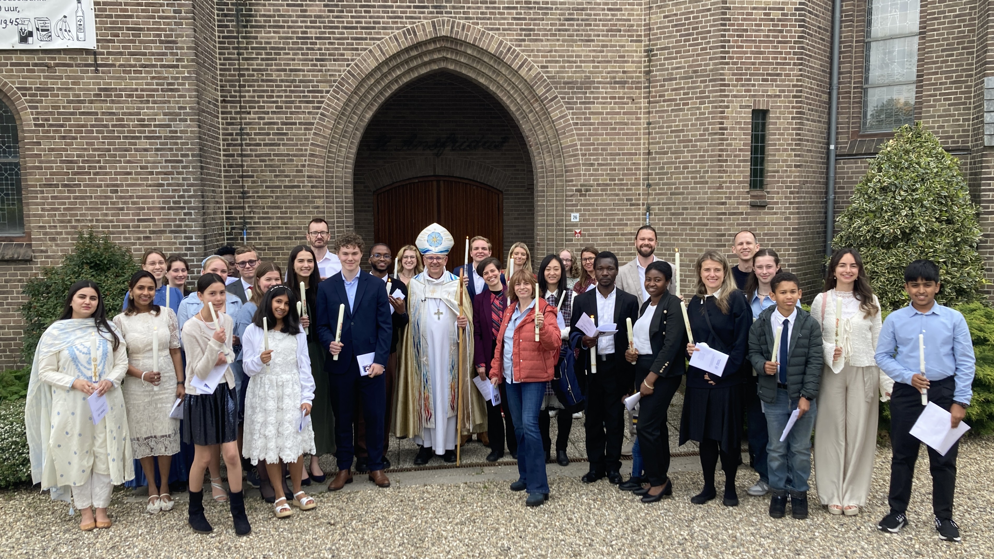 Clergy, confirmands outside a church