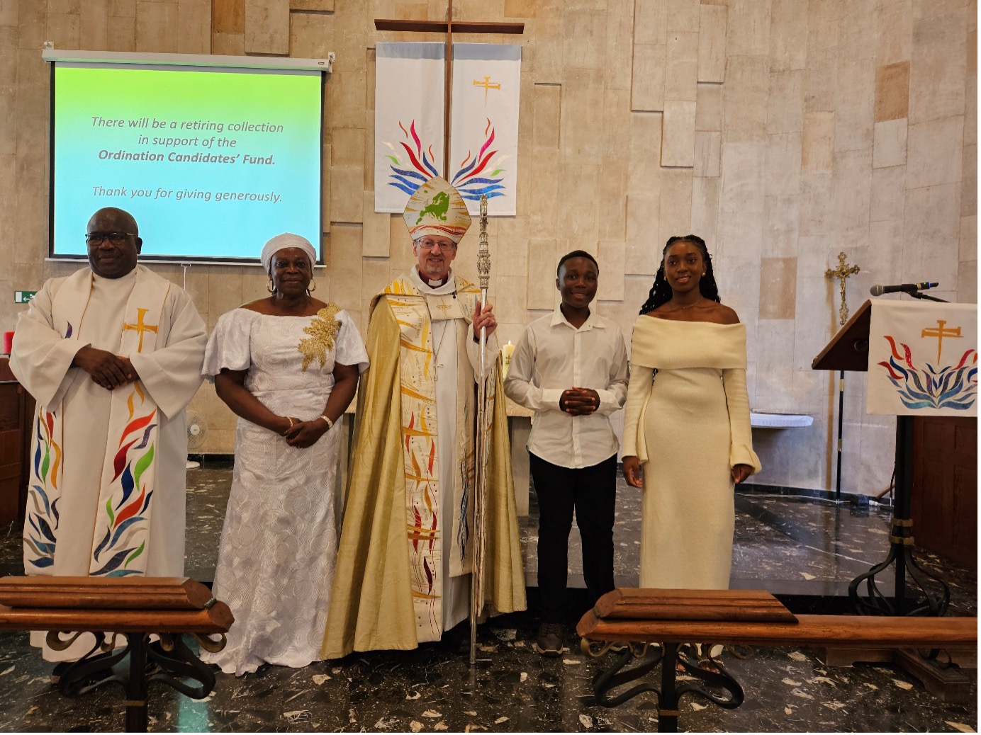 Bishop and confirmands inside a church in a row