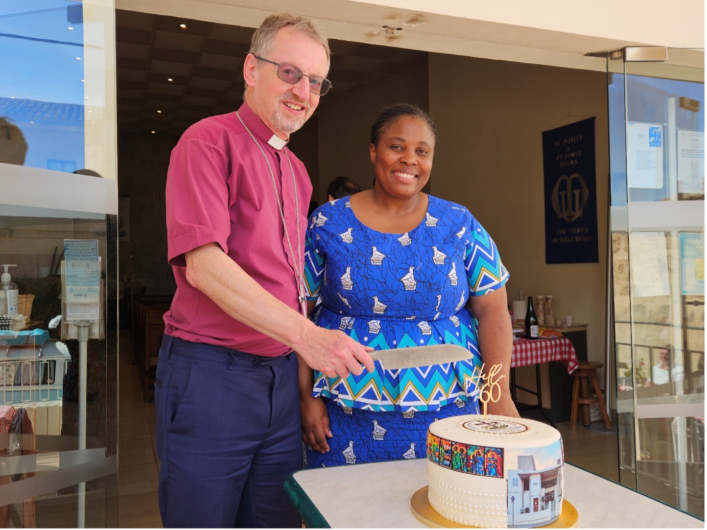 Bishop and lady cutting cake