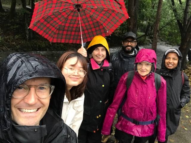 people hiking in the rain