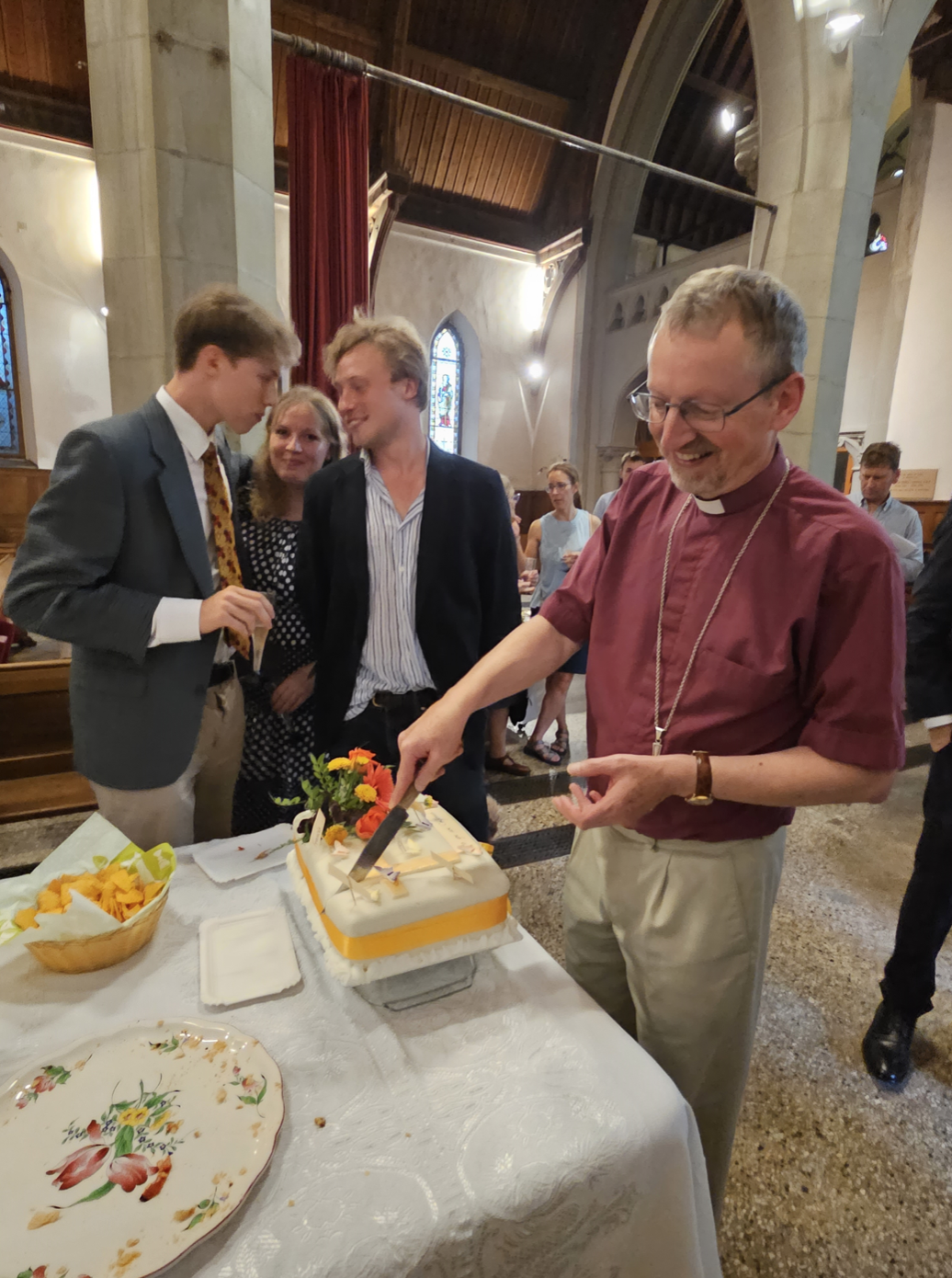 bishop robert cutting cake
