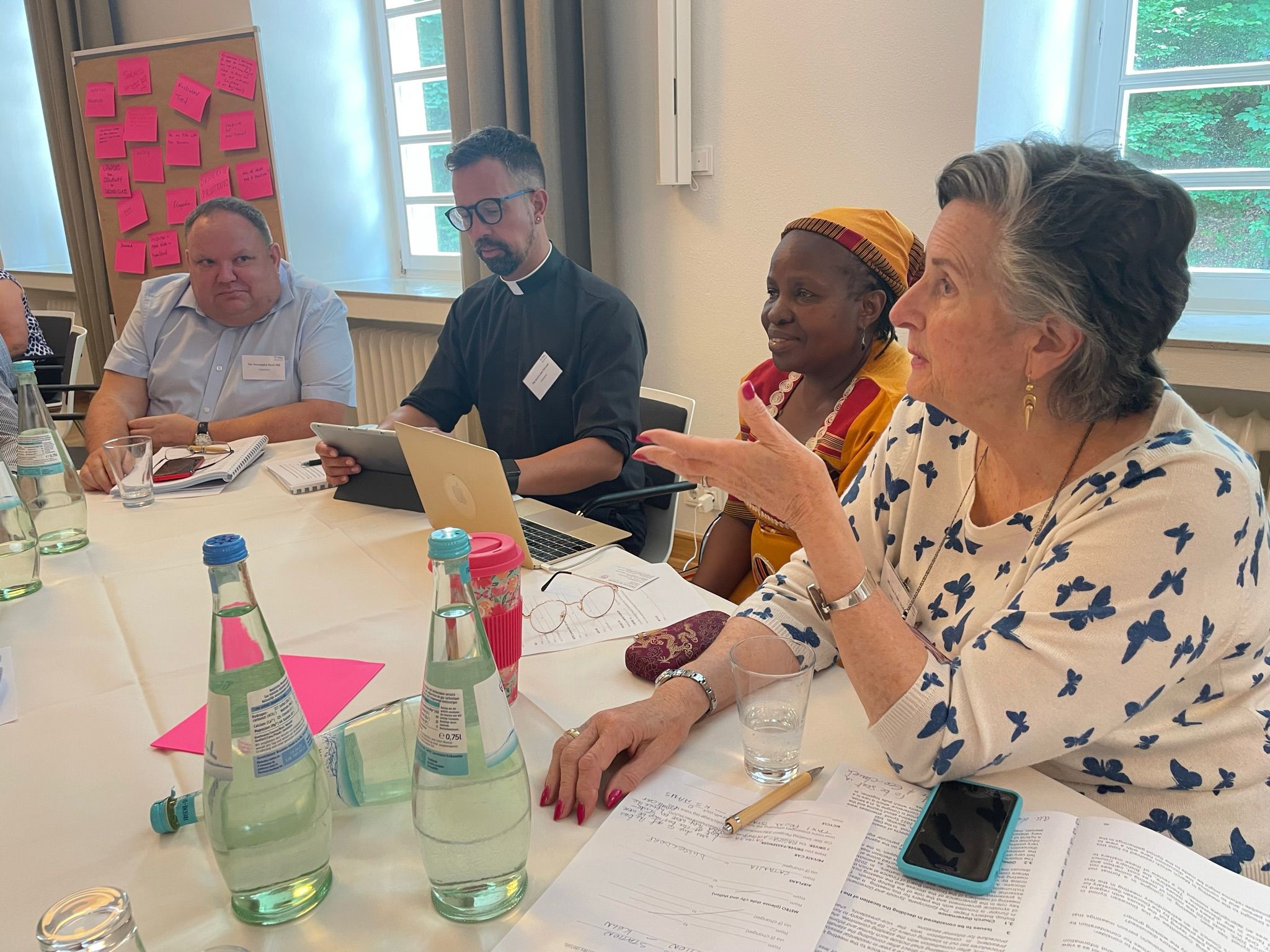 A woman leading a discussion around a table