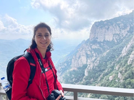 A person standing on a balcony with a camera
AI-generated content may be incorrect.