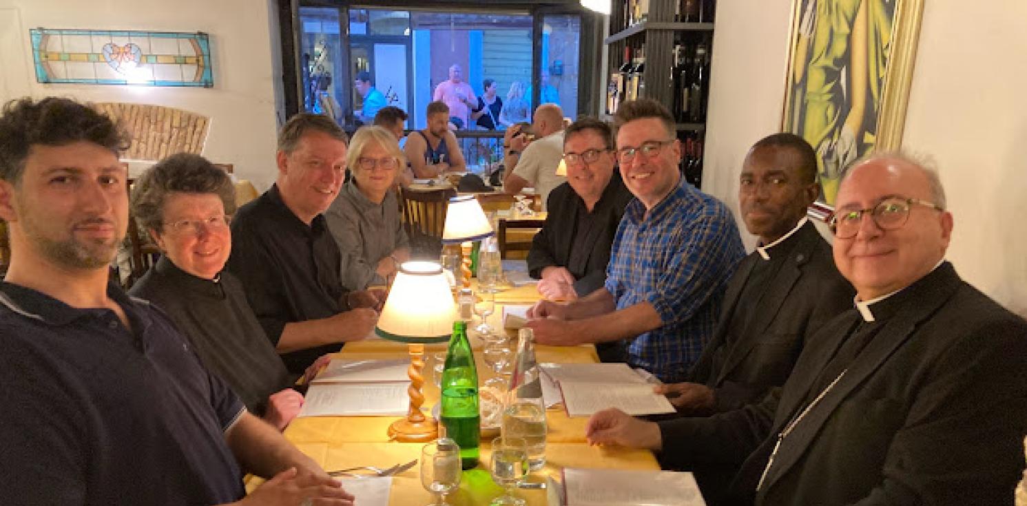 Bishop David and Clergy enjoying a meal together.