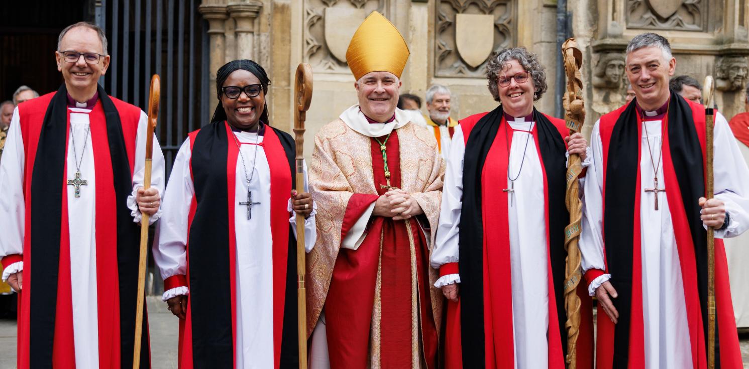Bishop Andrew stands with three other new bishops