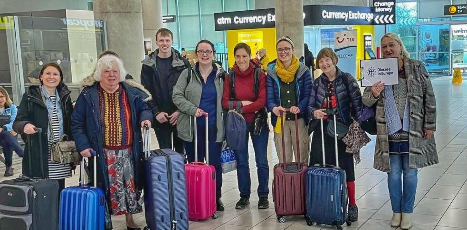 Group of people standing at the airport with their luggage