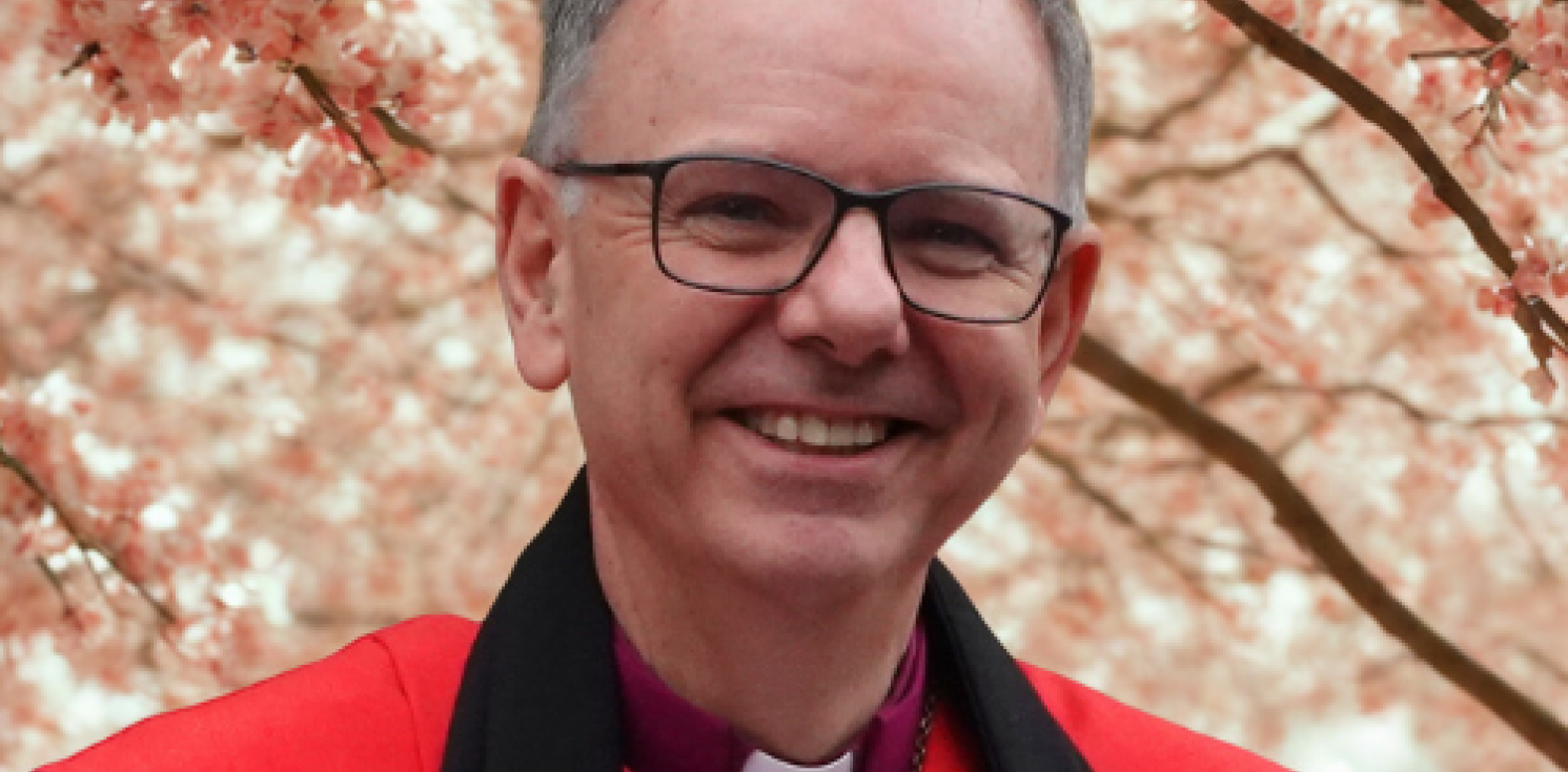 Bishop Andrew in front of a blossoming tree