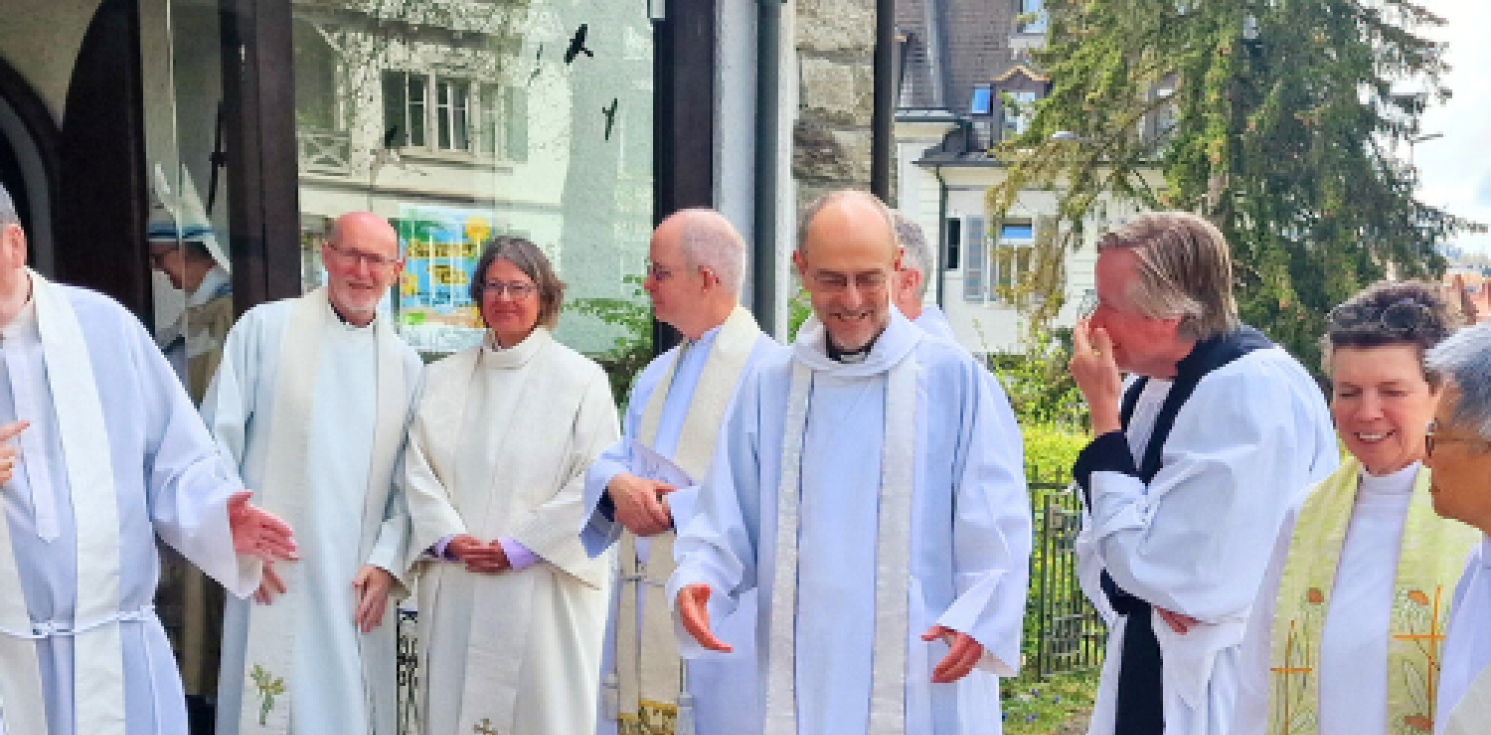 Clergy talking outside a church