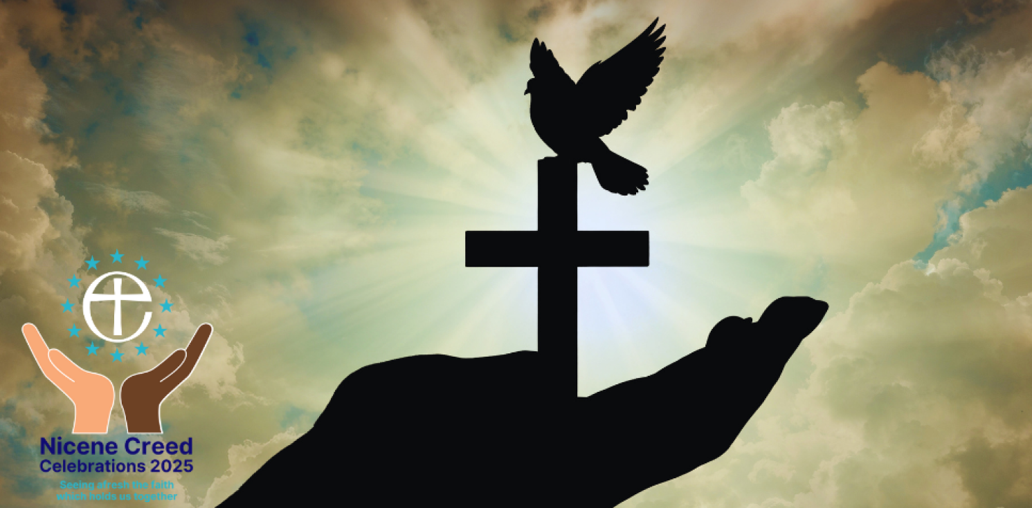 Silhouette of a hand holding a cross and dove
