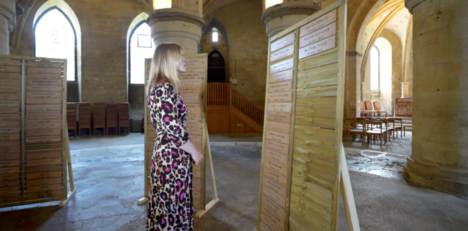 Lady looks at names on a memorial
