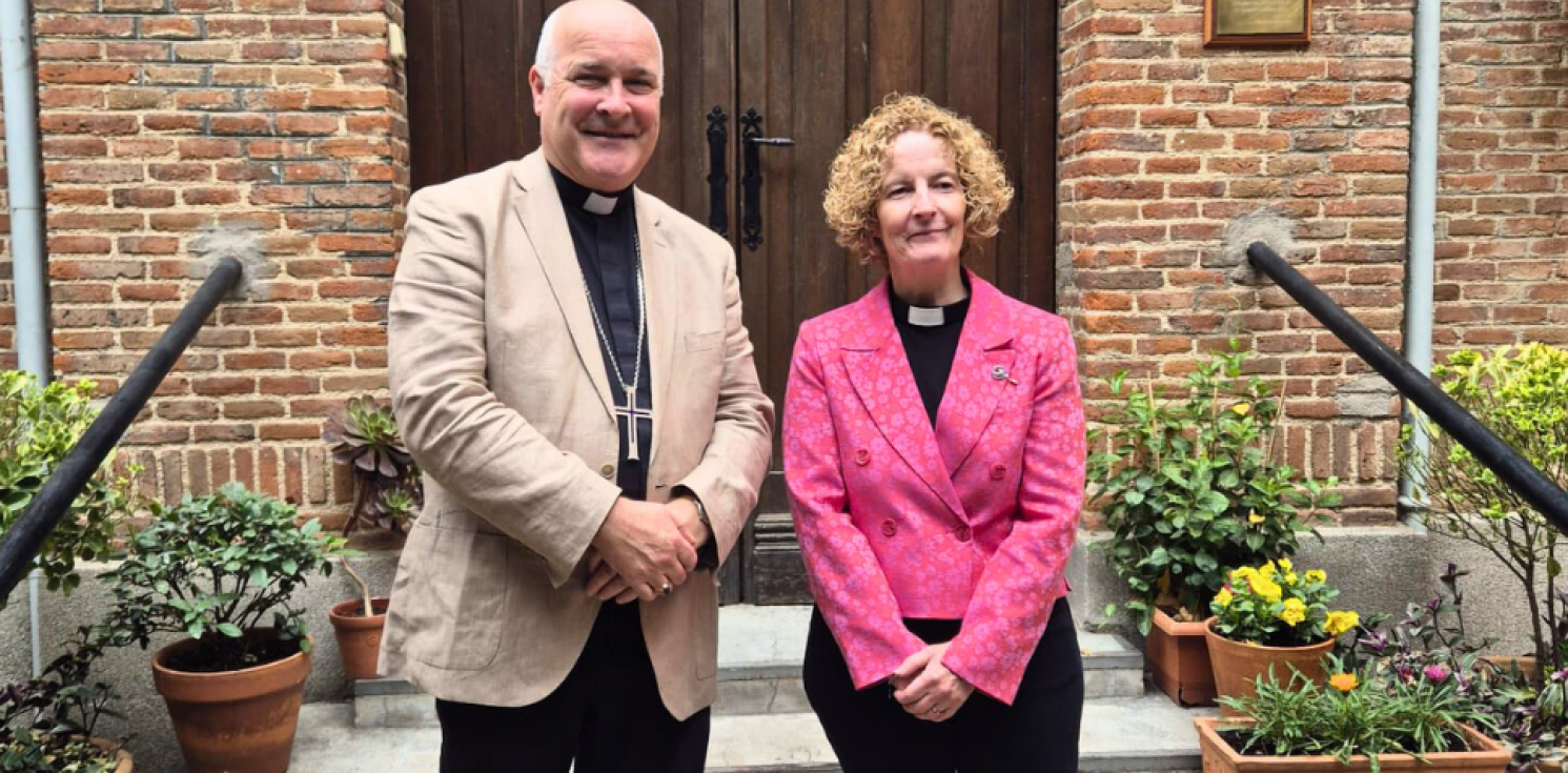 Archbishop and vicar in front of a church