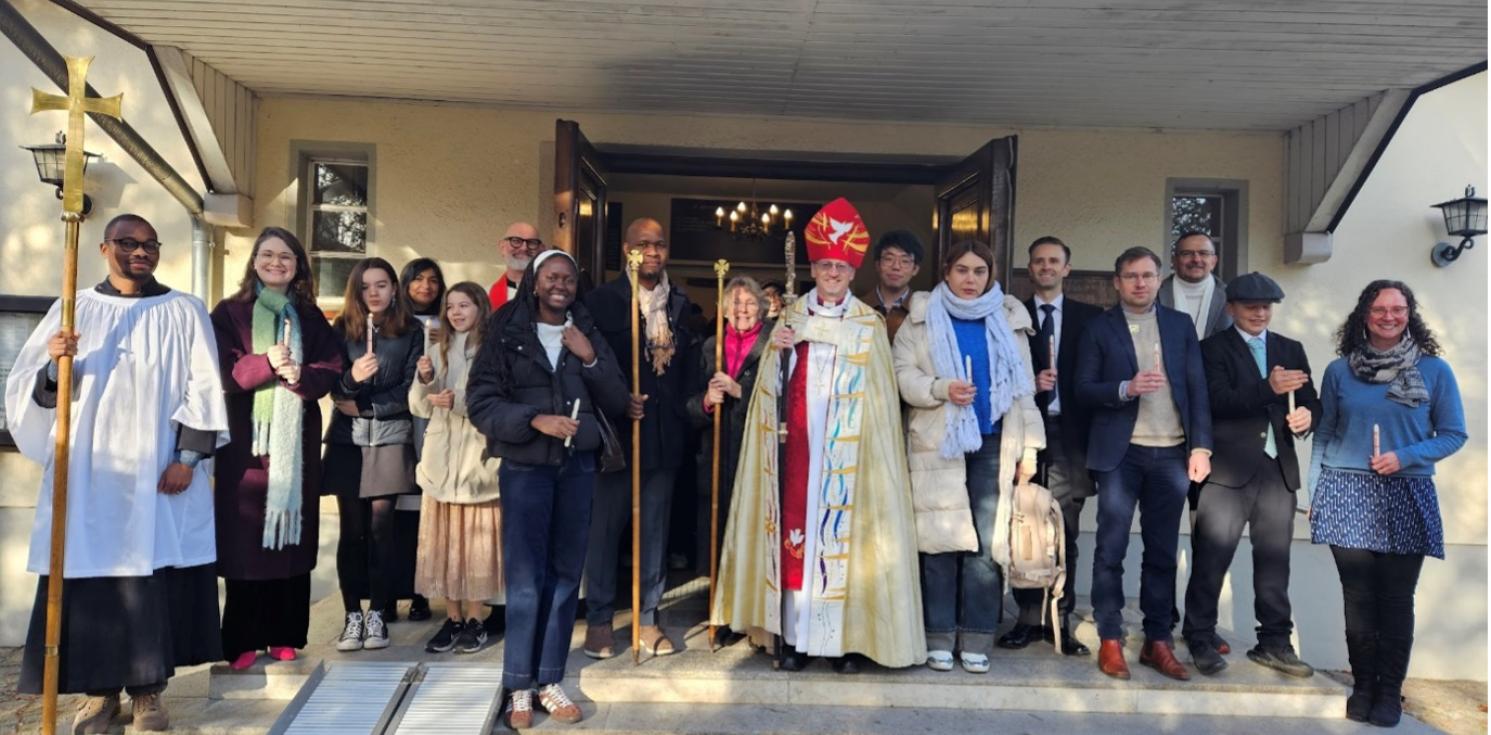 A congregation and a bishop outside a church