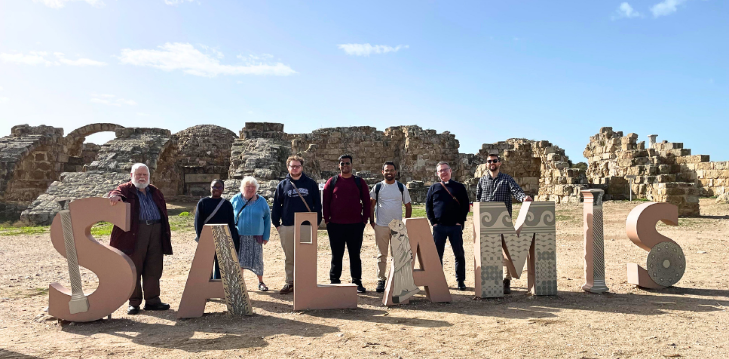 large letters spell Salamis with people standing with them