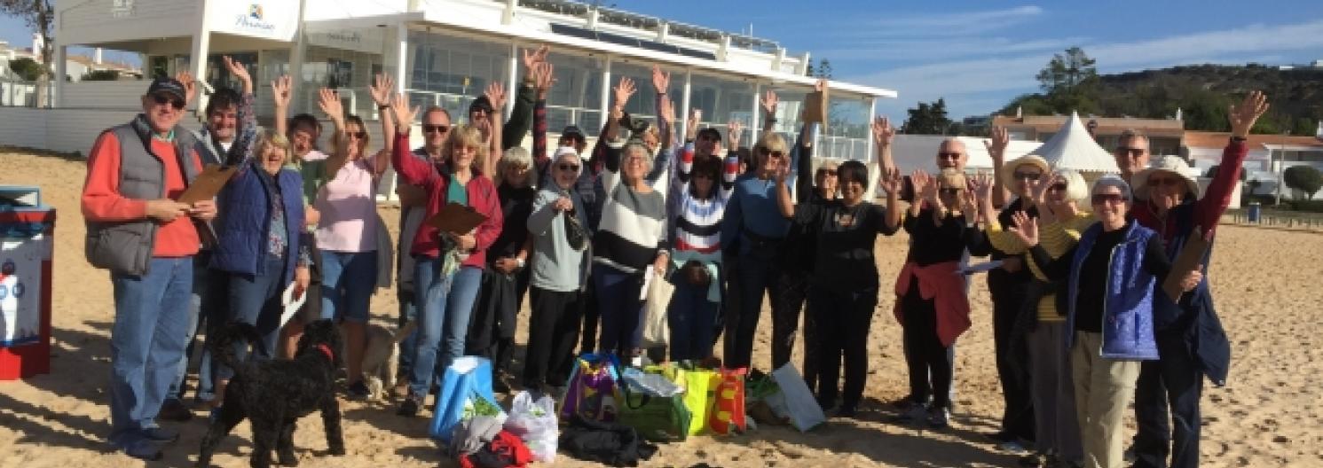 A group on the beach after a beach clean up event.