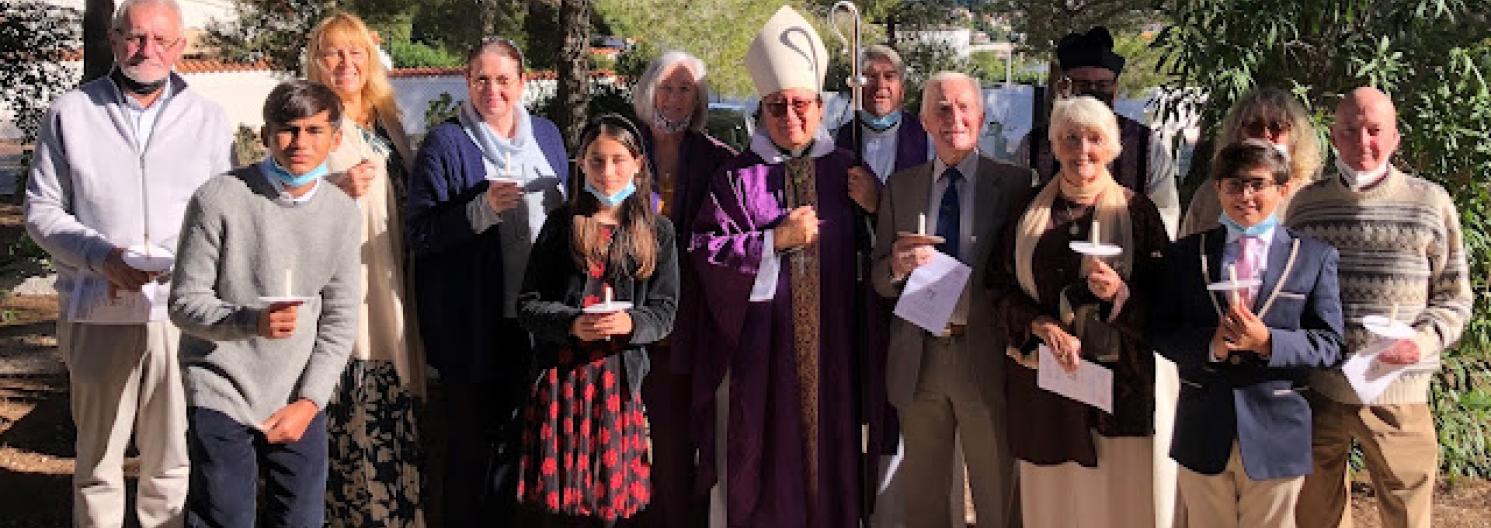 The congregation gathered around Bishop David.