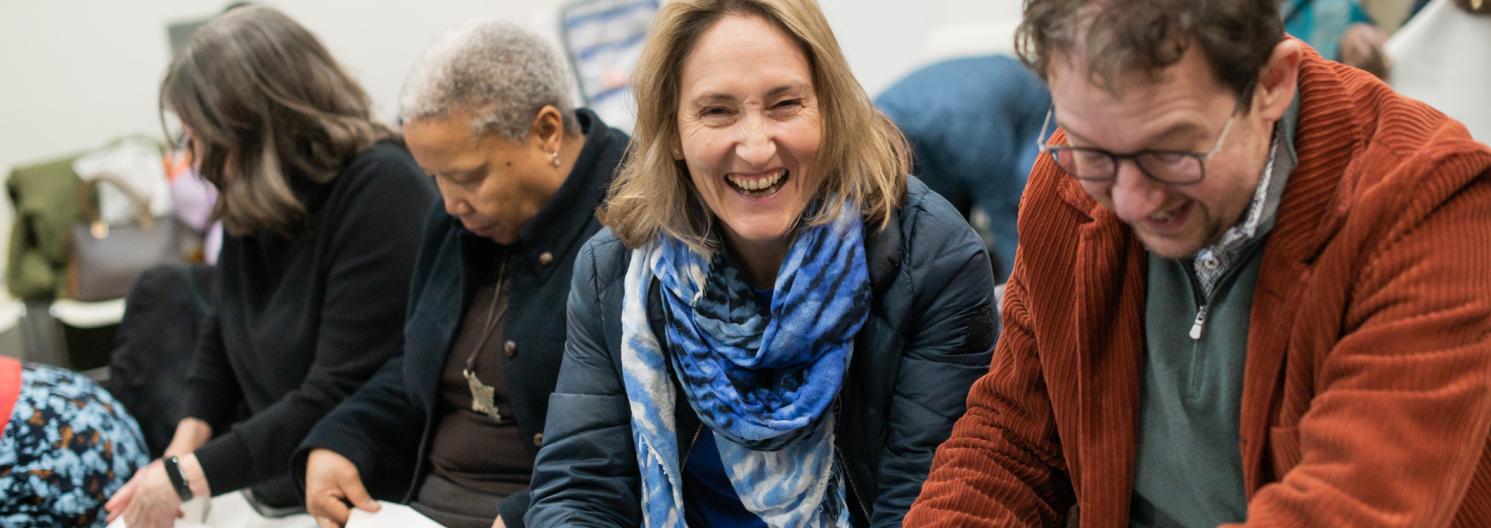 woman laughing making a paper hat