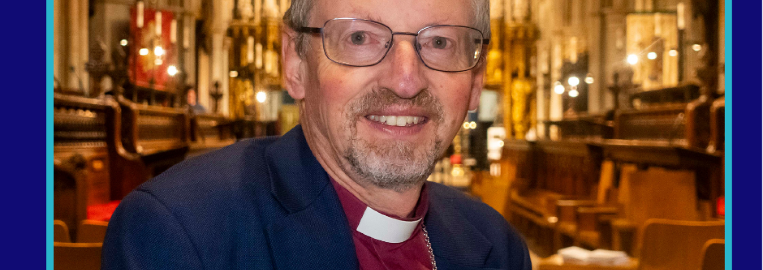 Bishop Robert smiles to camera