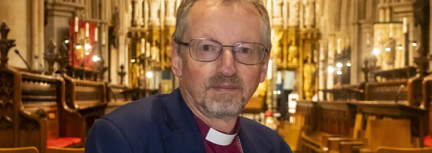 Bishop Robert looking to camera without smiling