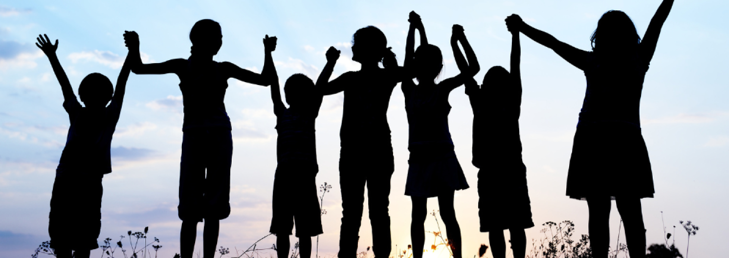 silhouettes of a row of children holding hands