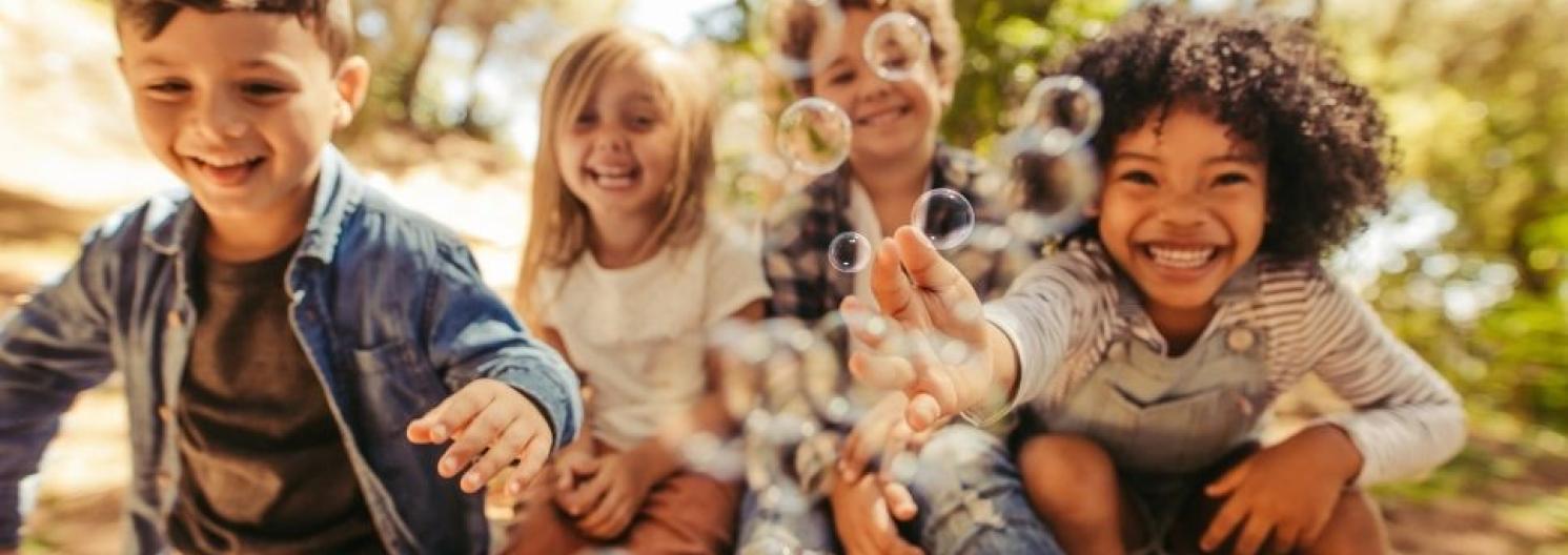 4 children blowing bubbles