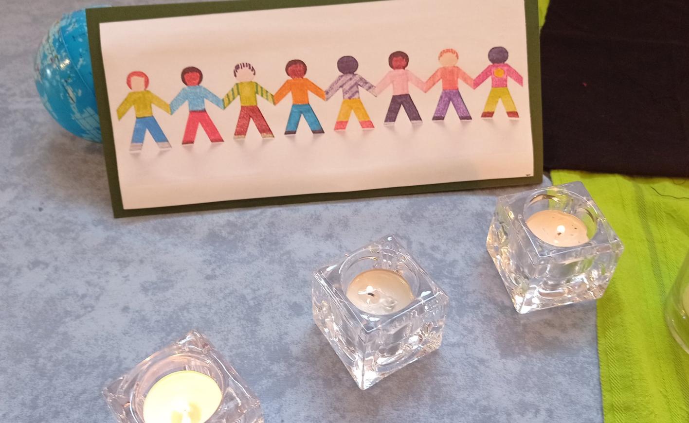 drawing of people holding hands and tea light candles around