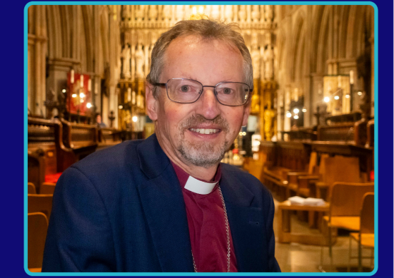Bishop Robert smiles to camera