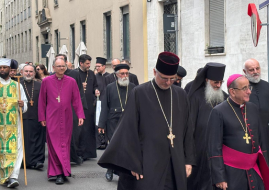 Priests from different traditions walk towards the camera up a road