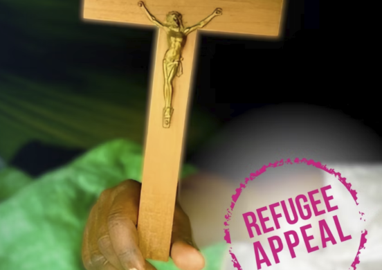 A hand holds a crucifix