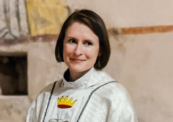 female chaplain smiles