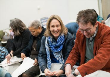 woman laughing making a paper hat