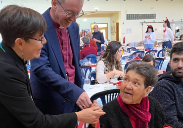 bishop and chaplain talking to an elderly lady