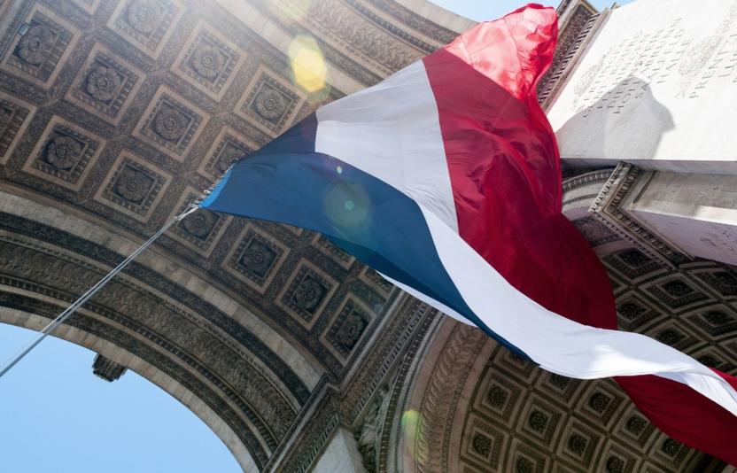 A french flag flying in the wind.