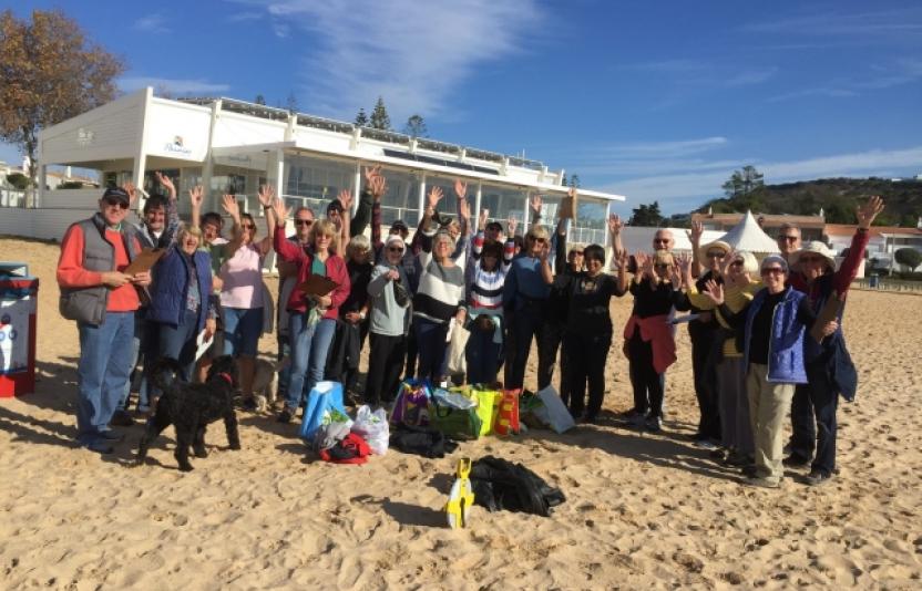 A group on the beach after a beach clean up event.